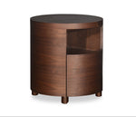 Wooden side table with a round top and curved sides on a white background