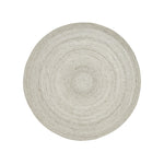 A round, beige area rug with a swirling geometric design
