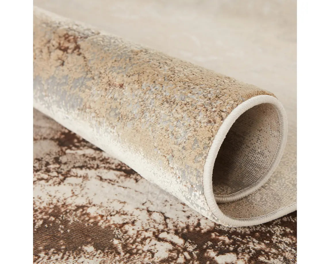 A rectangular area rug with a marble-like pattern in brown and gray tones.