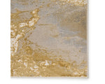 A power loomed area rug with a gold color pattern