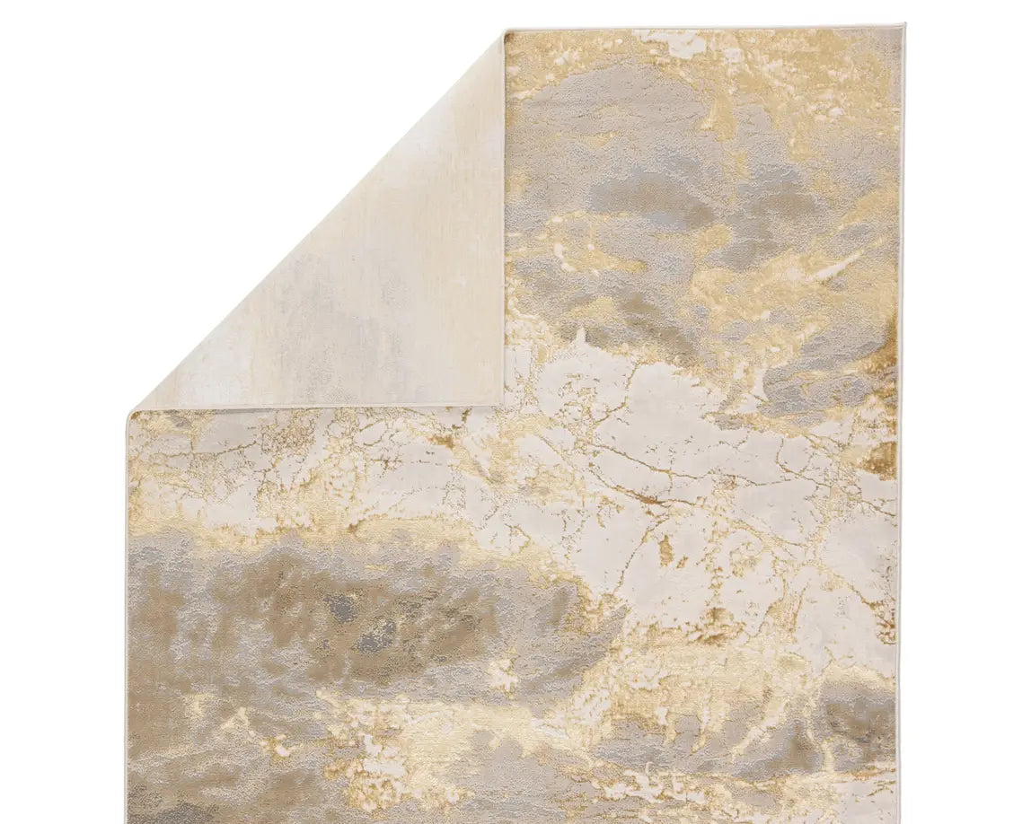 A power loomed area rug with a gold color pattern