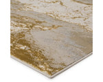 A power loomed area rug with a gold color pattern