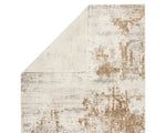 A power loomed area rug with a distressed texture design in beige and brown tones.