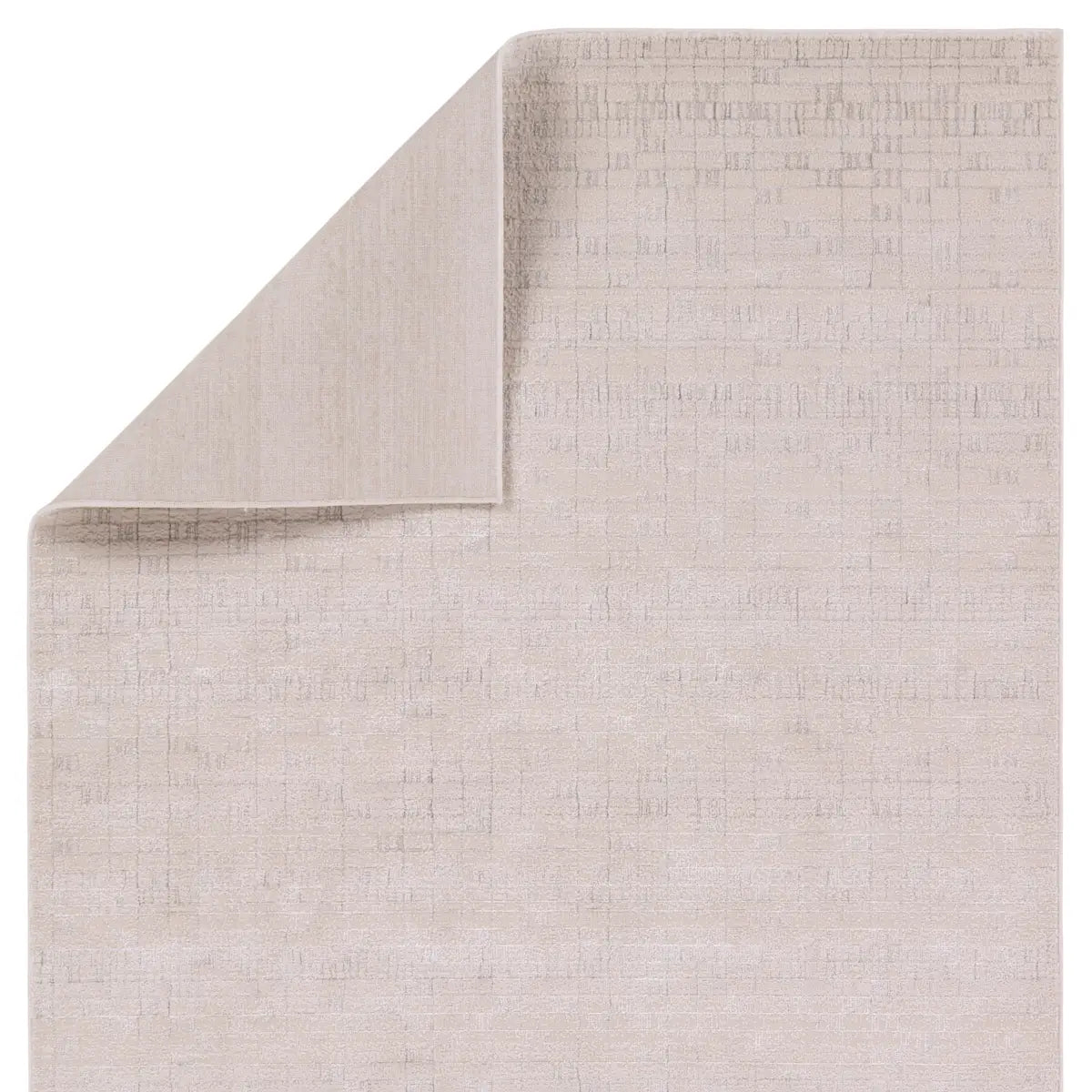 A beige area rug with a textured surface, power loomed construction, and a visible brand tag.
