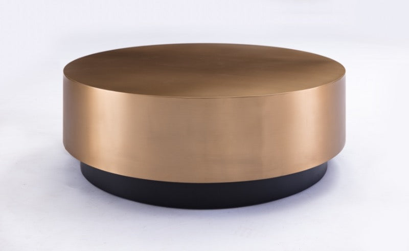 Round metallic coffee table with bronze top and black base on a white background