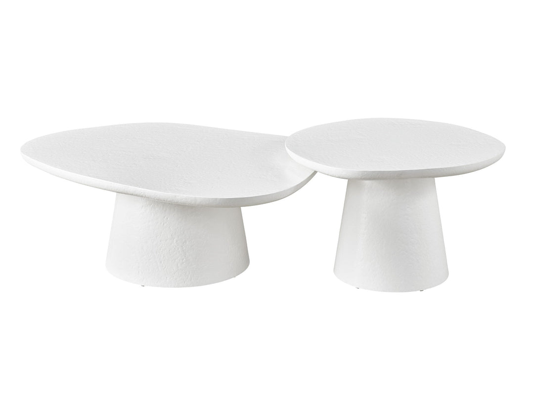 Two white nesting coffee tables made of textured plaster, with the smaller table placed under the larger one.