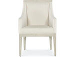 A beige upholstered dining chair with armrests and wooden legs, viewed from a front angle.