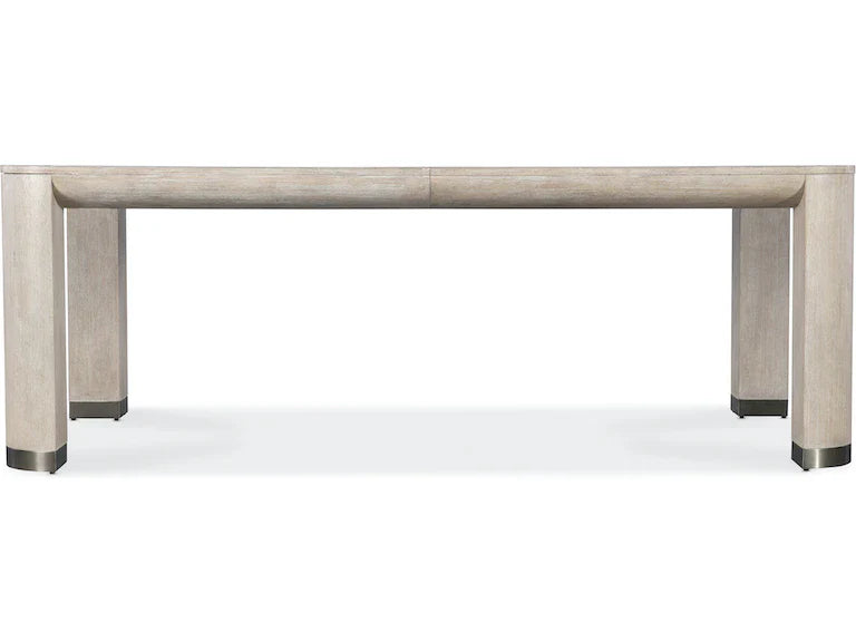 Dining table with a light wood finish on a white background