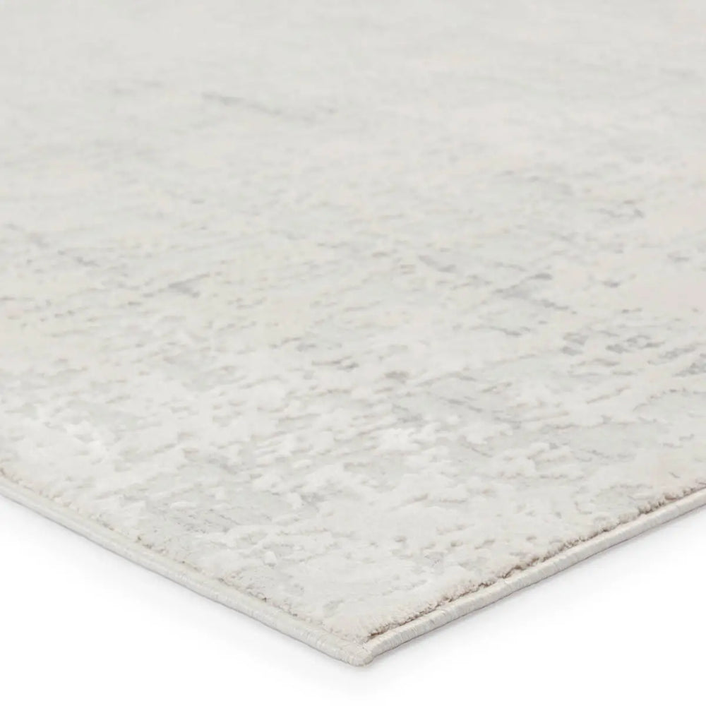 A plain gray area rug with no visible patterns or textures.
