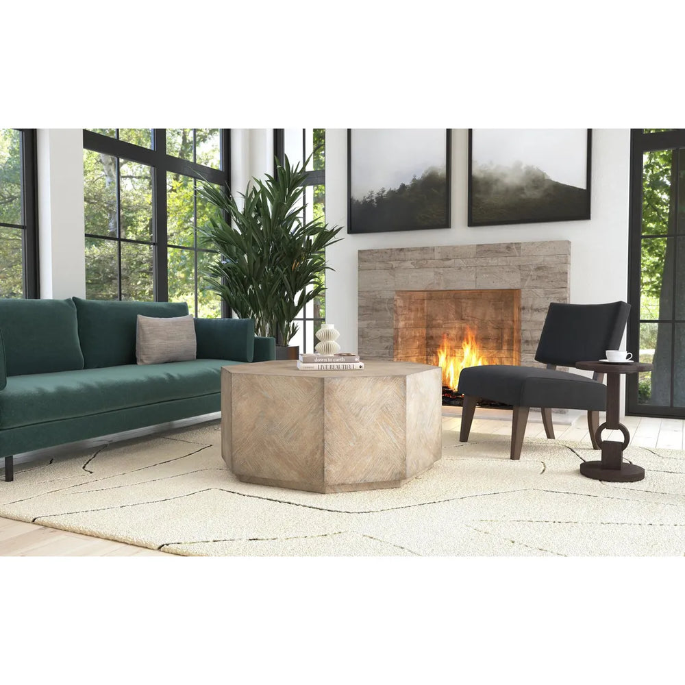 Modern living room with a green sofa, stone coffee table, and fireplace.
