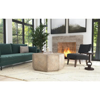 Modern living room with a green sofa, stone coffee table, and fireplace.