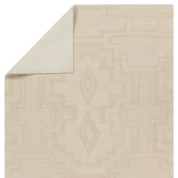 Beige area rug with geometric pattern on a white background
