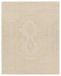 Beige area rug with geometric pattern on a plain background