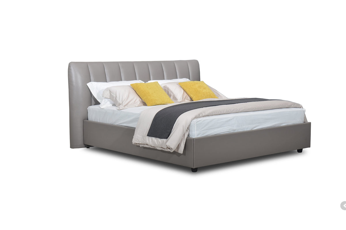 A gray upholstered Cony bed frame with a headboard, made from Italian full grain leather, with a mattress on top.