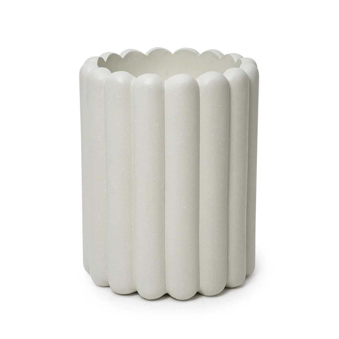 A beige cylindrical fiberglass planter with a ribbed design.