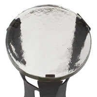 Round metallic object with a reflective surface on a white background