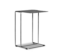 Modern side table with black top and chrome frame on a white background