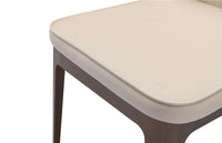 A beige upholstered dining chair with a high backrest and a straight seat type, isolated on a white background.