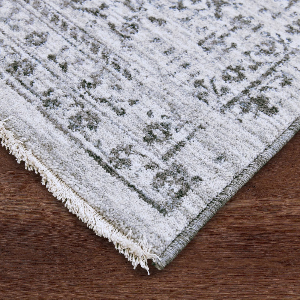 Close-up of a textured rug with geometric pattern on a wooden floor