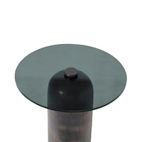 Round glass table with a metallic base on a white background