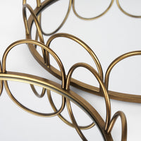 Two gold-colored metal serving trays with a geometric pattern.
