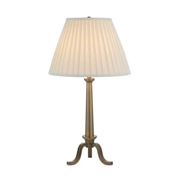 Table lamp with pleated white shade on a white background