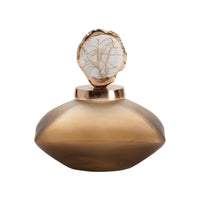 A gold-colored bottle accent with a textured surface and a rounded shape designed to sit on top of a bottle.