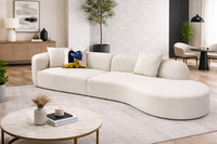 Modern living room with a white sectional sofa, coffee table, and decor items.
