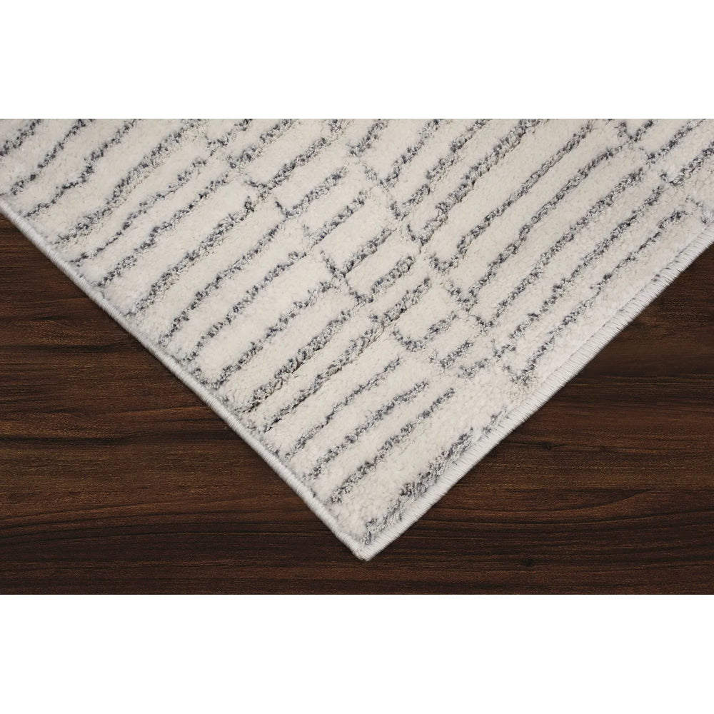 Textured area rug with a neutral color palette on a white background