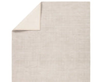 A light taupe area rug with a textured weave, handwoven from 100% pet yarn.
