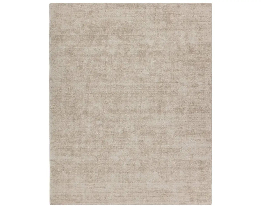 A rectangular taupe-colored area rug with a textured weave pattern.