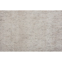 A light beige, solid pattern area rug.