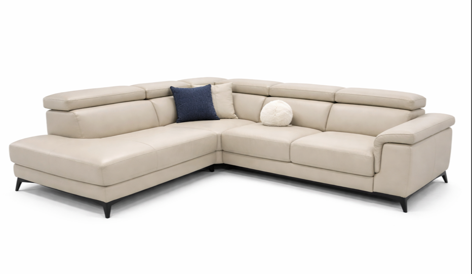 Beige sectional sofa with a blue pillow on a white background