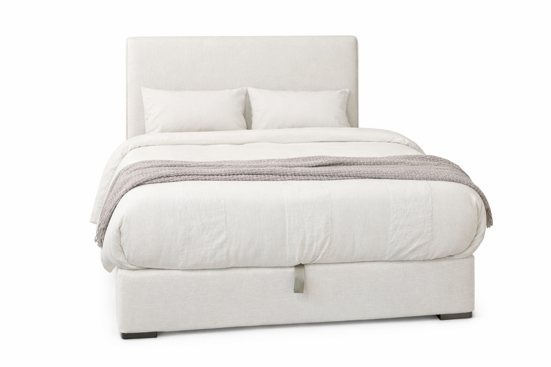 White bed with gray bedding on a white background