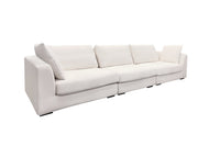 A beige luxury sectional sofa with multiple cushions, featuring a subtle curve design, set against a white background.