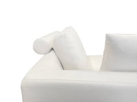 A beige luxury sectional sofa with multiple cushions, featuring a subtle curve design, set against a white background.