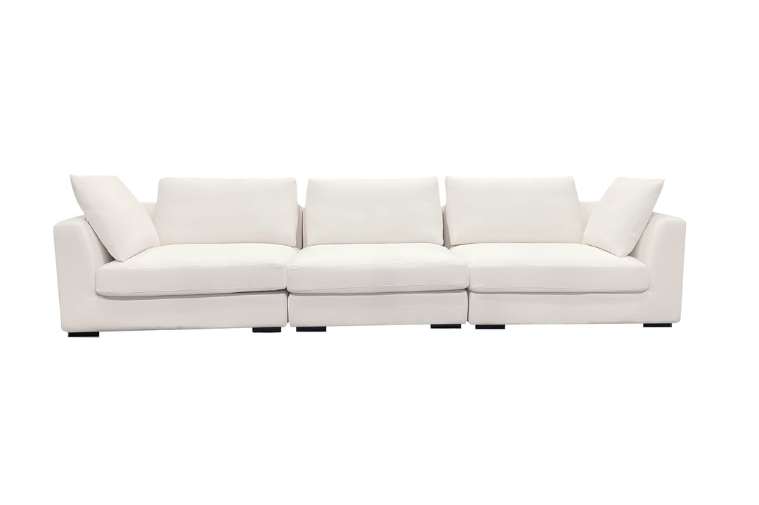 A beige luxury sectional sofa with multiple cushions, featuring a subtle curve design, set against a white background.