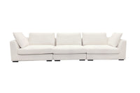 A beige luxury sectional sofa with multiple cushions, featuring a subtle curve design, set against a white background.