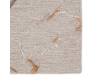A dark dove and gold area rug with a textured surface featuring cracks and seams, resembling a natural stone or marble appearance.