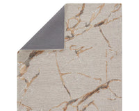 A dark dove and gold area rug with a textured surface featuring cracks and seams, resembling a natural stone or marble appearance.