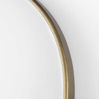 An oval-shaped full-length mirror with an antique-gold finish and a decorative bezel.