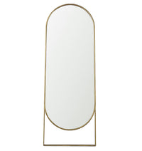 Oval-shaped mirror with a gold frame on a white background