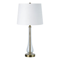Table lamp with white shade and clear glass base on a white background