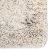 Close-up of a textured beige and gray rug