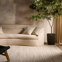 A beige area rug with a solid pattern and flat texture.