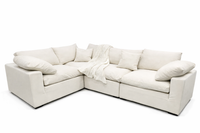 White sectional sofa with cushions on a white background