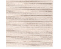 A beige and white striped area rug, power loomed with a flatweave construction.