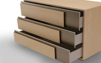 A beige wooden sideboard with three drawers and a lower shelf, against a white background.