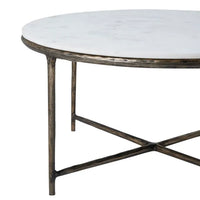Round marble coffee table with a cast aluminum base featuring a natural white color and antique brass finish.