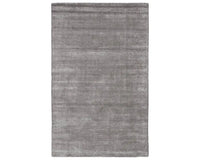A dark gray area rug with a textured weave, handwoven from a blend of wool and viscose.